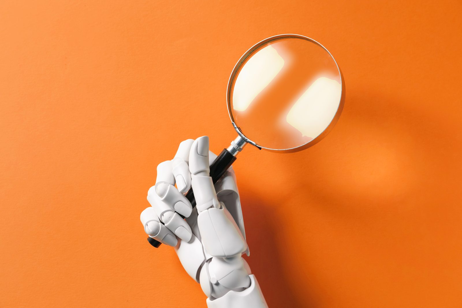 A white robotic hand holding a magnifying glass against an orange background, representing AI searching for local businesses
